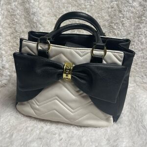Betsey Johnson off white & Black quilted faux leather satchel with bow accent